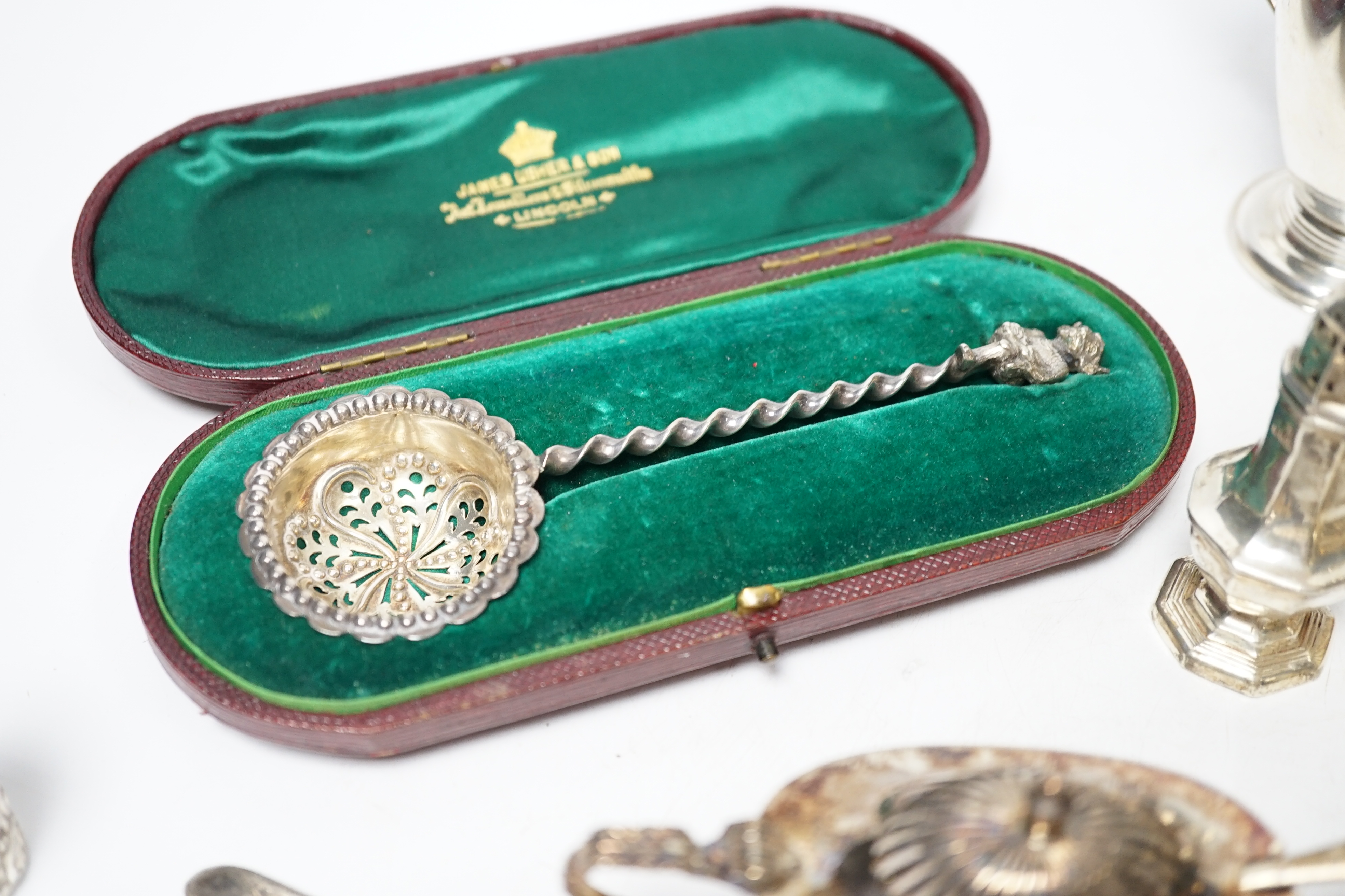 A group of small silver including Edwardian silver oval sugar basket, a modern silver cream jug and sugar bowl, five assorted condiments, a silver sifter spoon and a late Victorian scent bottle, 56mm.